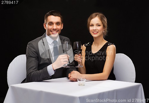 Image of young couple with glasses of wine at restaurant