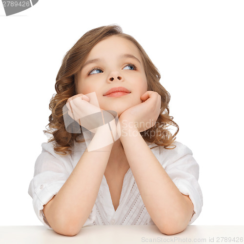 Image of pre-teen girl in casual clothes looking up