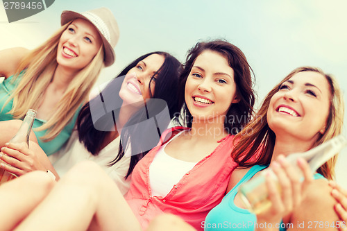 Image of girls with drinks on the beach