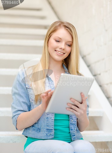 Image of smiling female student with tablet pc computer