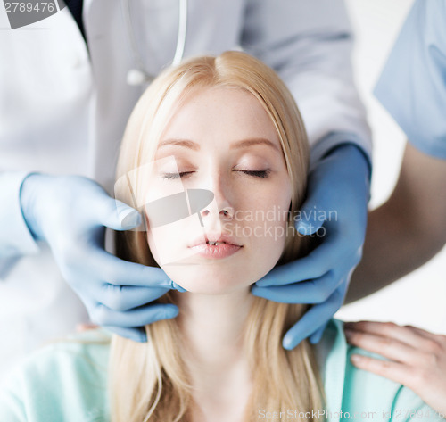 Image of plastic surgeon or doctor with patient