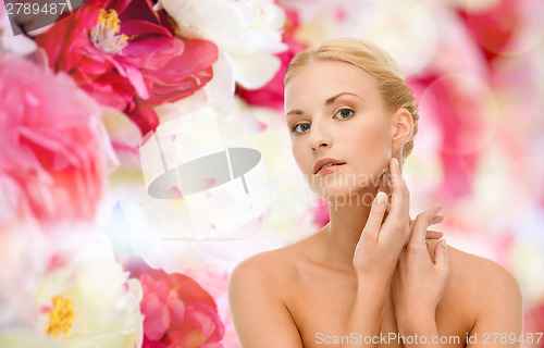 Image of beautiful woman touching her face skin