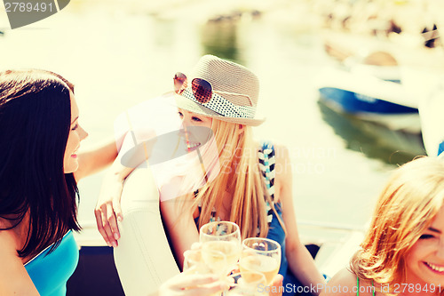 Image of girls with champagne glasses on boat