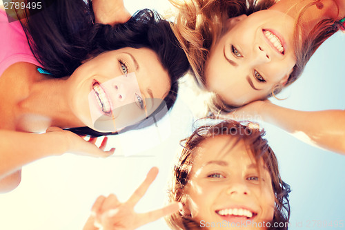 Image of girls faces with shades looking down