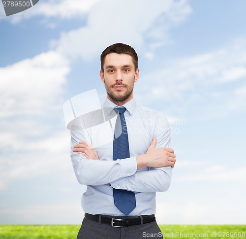 Image of handsome businessman with crossed arms