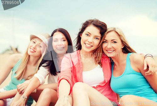 Image of girls with drinks on the beach
