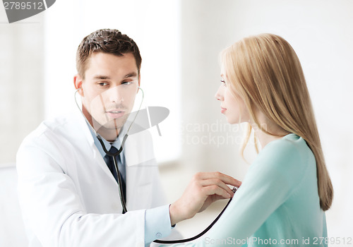 Image of doctor with stethoscope listening to the patient