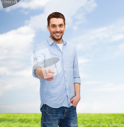 Image of smiling man pointing finger at you