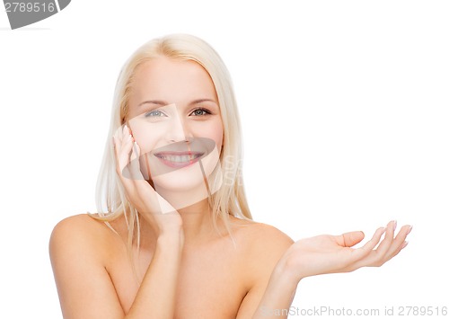 Image of smiling woman holding imaginary lotion jar