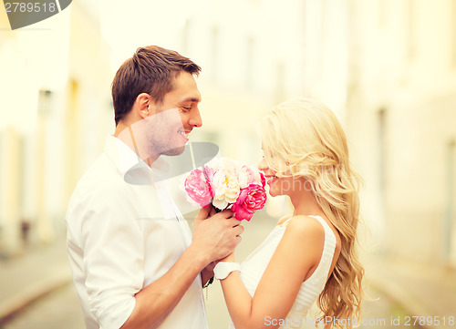 Image of couple with flowers in the city