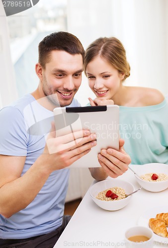 Image of smiling couple with taking picture with tablet pc