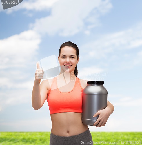 Image of teenage girl with jar of protein showing thumbs up