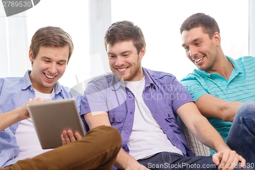 Image of smiling friends with tablet pc computers at home