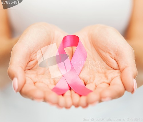 Image of hands holding pink breast cancer awareness ribbon