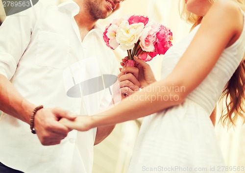 Image of couple with flowers in the city