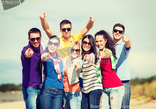 Image of group of friends having fun on the beach