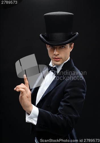 Image of magician in top hat showing trick