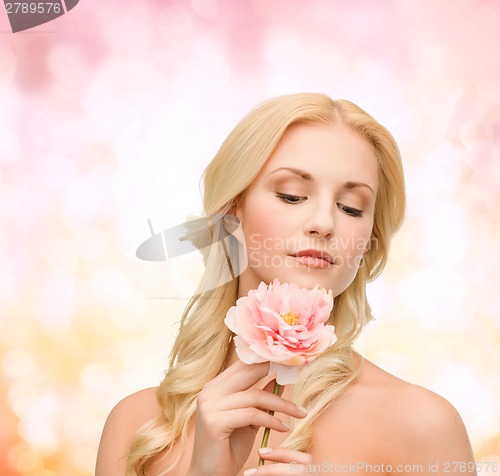 Image of lovely woman with peony flower