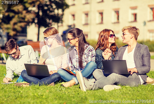 Image of students or teenagers with laptop computers