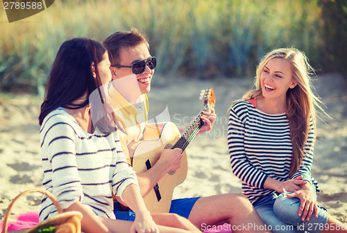 Image of group of friends having fun on the beach