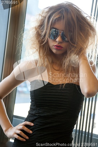 Image of beautiful young woman in sunglasses