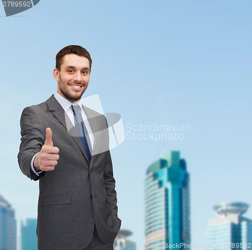 Image of handsome buisnessman showing thumbs up
