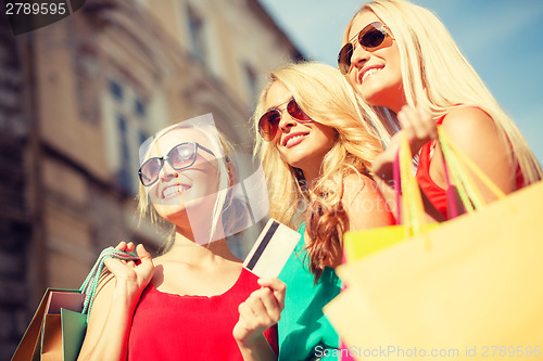 Image of beautiful women with shopping bags in the ctiy