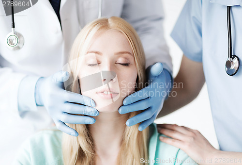 Image of plastic surgeon or doctor with patient