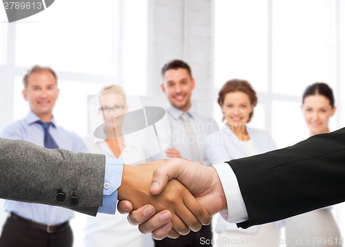 Image of businessman and businesswoman shaking hands