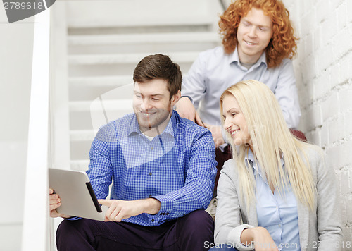 Image of team with tablet pc computer sitting on staircase