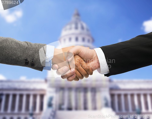 Image of businessman and businesswoman shaking hands