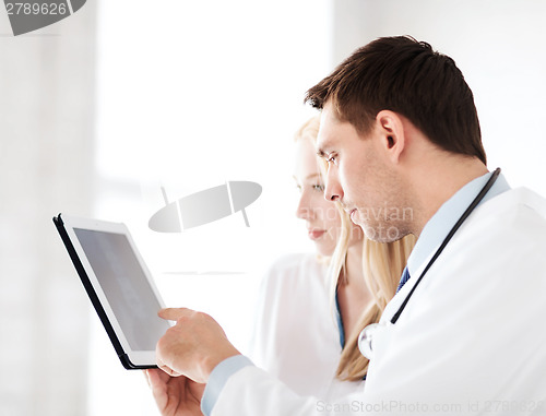 Image of two doctors looking at x-ray on tablet pc