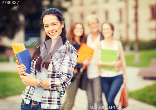 Image of teenage girl with folders and mates on the back