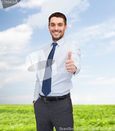Image of handsome businessman showing thumbs up