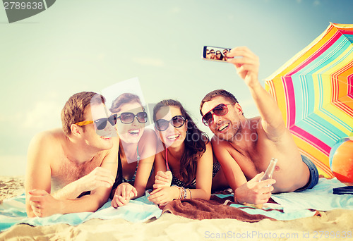 Image of group of people taking picture with smartphone