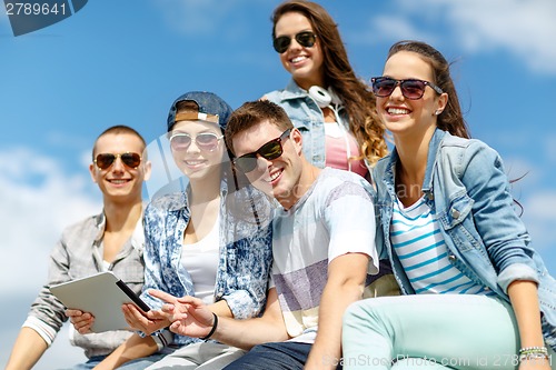 Image of group of teenagers looking at tablet pc computer