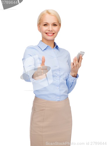 Image of young smiling businesswoman with smartphone