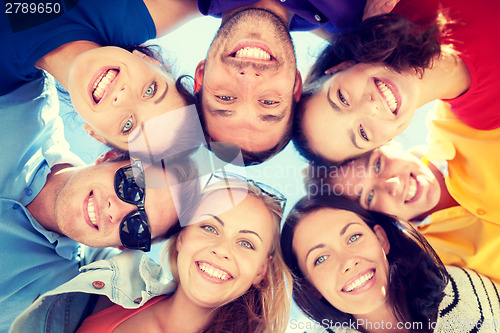 Image of group of teenagers looking down