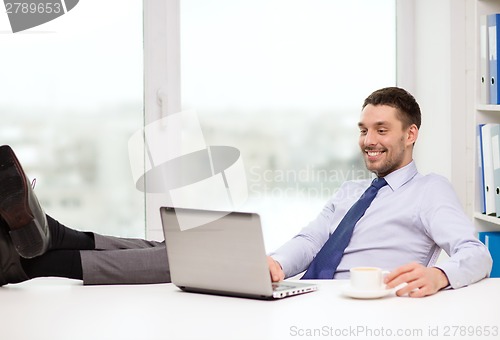 Image of smiling businessman or student with laptop