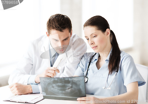 Image of two doctors looking at x-ray