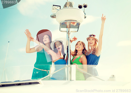 Image of girls waving on boat or yacht
