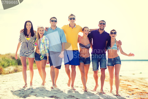 Image of group of friends having fun on the beach
