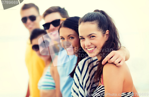 Image of group of friends having fun on the beach