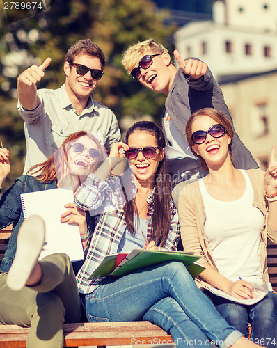 Image of students with books, notebooks, files and folders