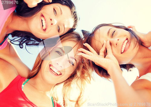 Image of girls faces with shades looking down