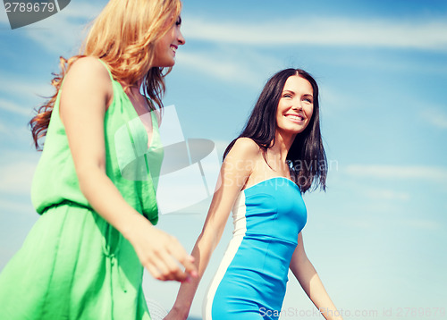 Image of girls walking on the beach