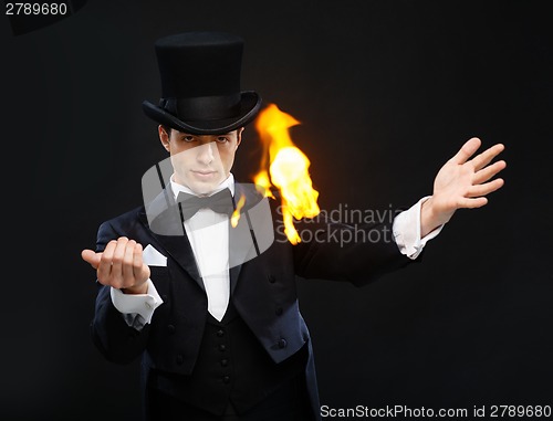 Image of magician in top hat showing trick with fire