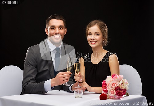 Image of couple with glasses of champagne at restaurant