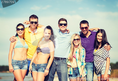 Image of group of friends having fun on the beach