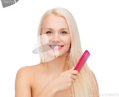 Image of smiling woman with hair brush